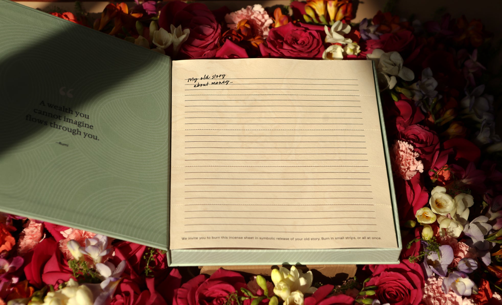 Prosperity Ritual Kit open the burnable, artisan incense paper on bed of roses. Affirmation card.mirror work.